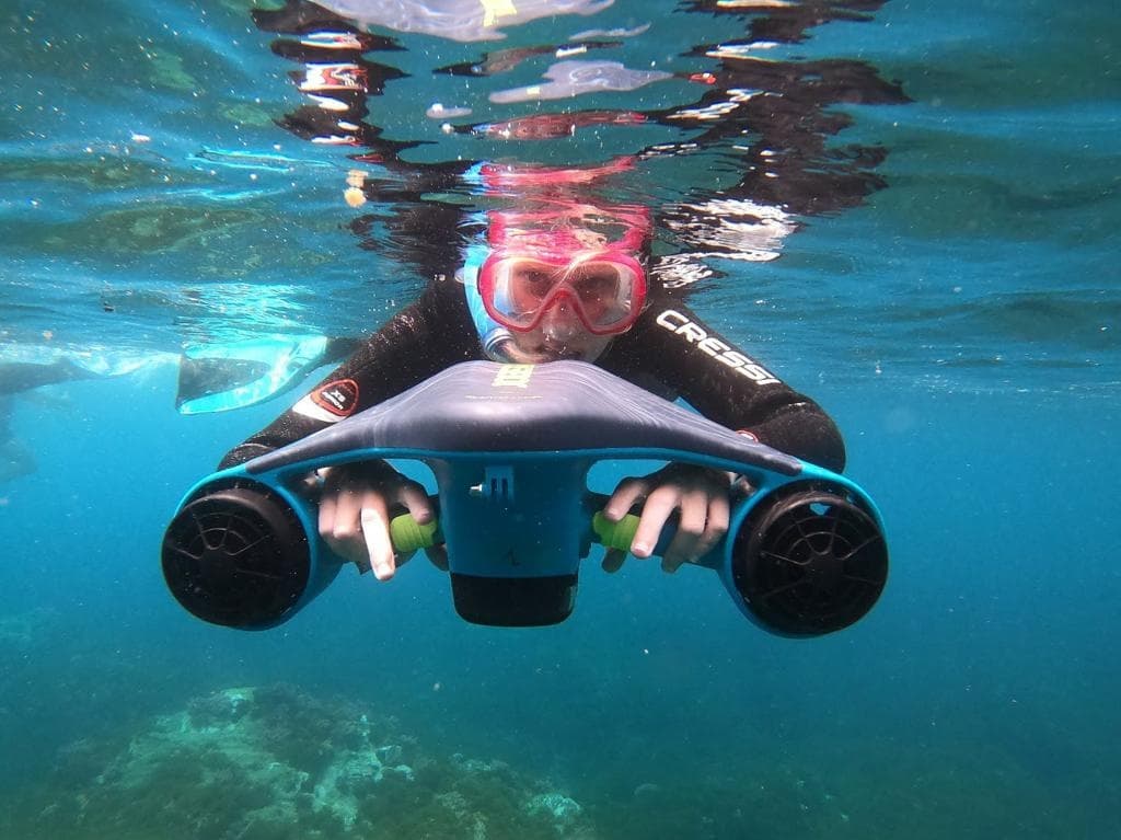 Explorer using an underwater scooter for snorkeling in the crystal-clear waters of Maro, Nerja.