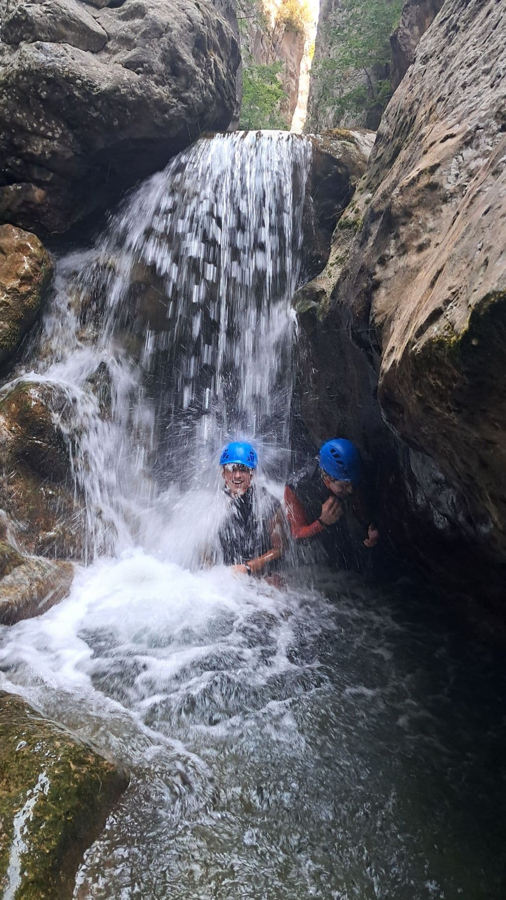 Canyoner rappelling down a waterfall within the narrow walls of the Congosto de Obarra.